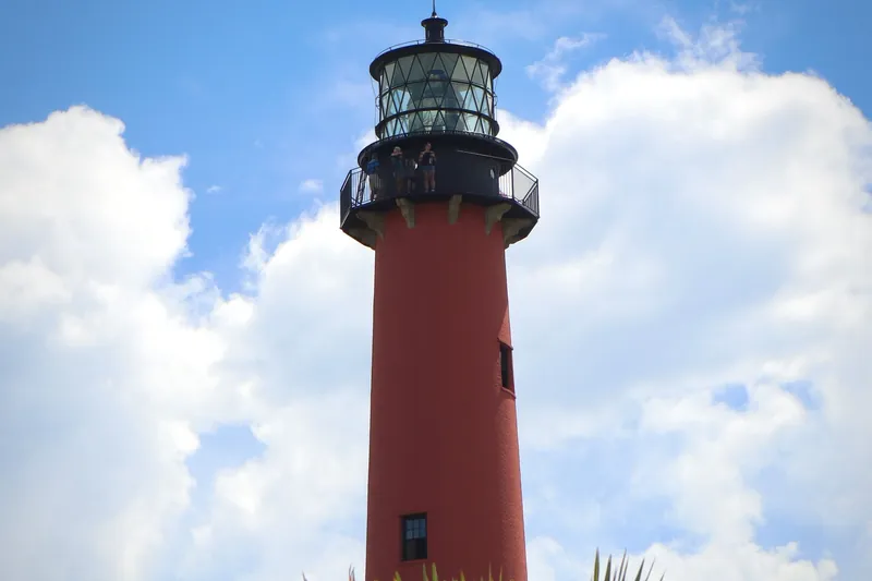 The red Jupiter Inlet Lighthouse under a blue sky